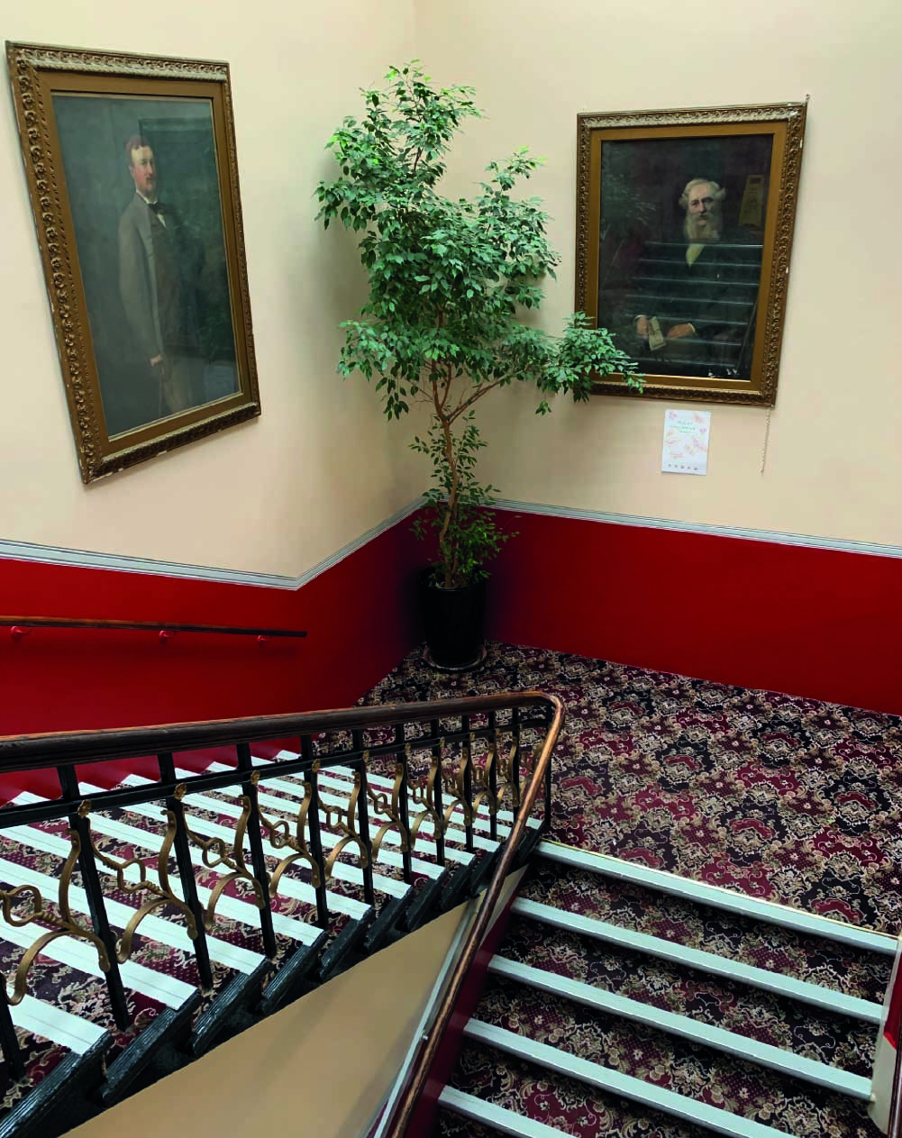 Staircase lobby with decorative carpet and red walls in turner home